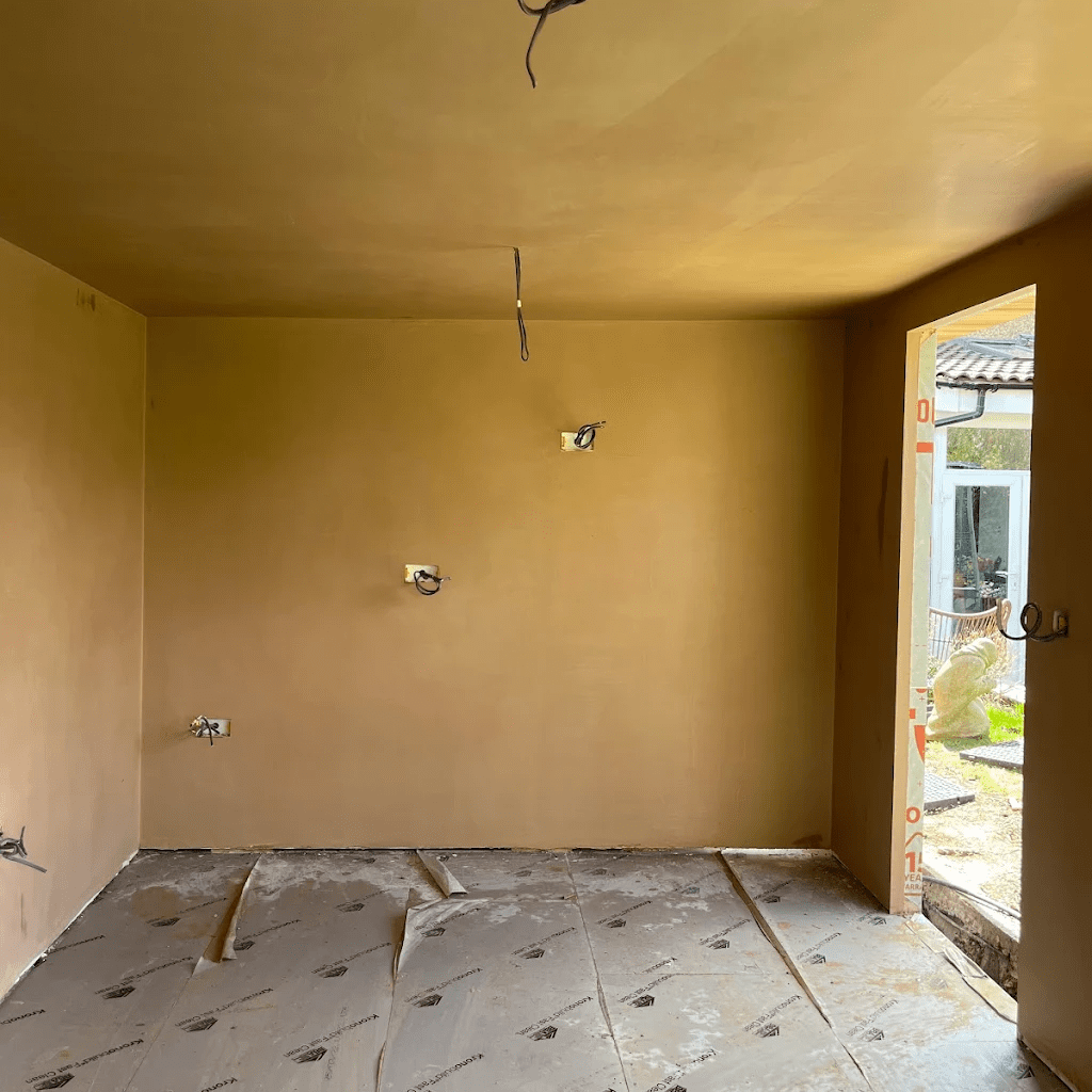 Freshly plastered room with smooth walls and ceiling ready for painting