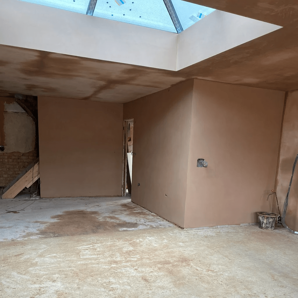 Newly plastered walls and ceiling with skylight.