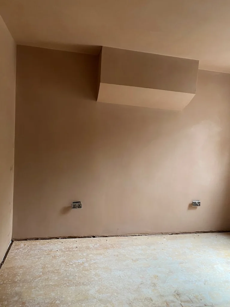 Plastered wall and ceiling feature in a room before final finishing