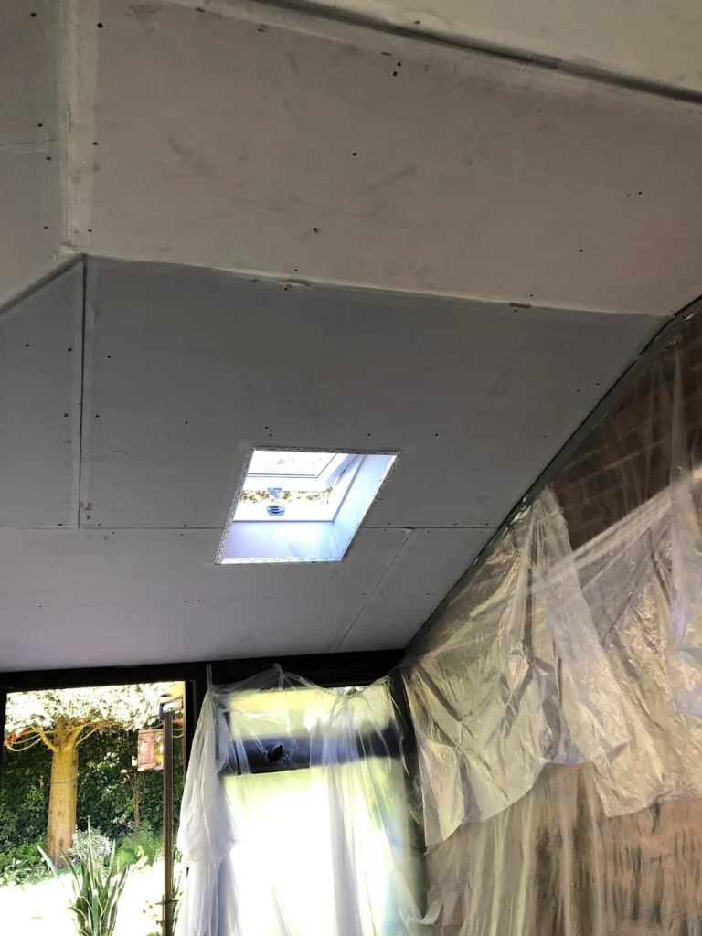 Plasterboard ceiling installation with skylight in a conservatory